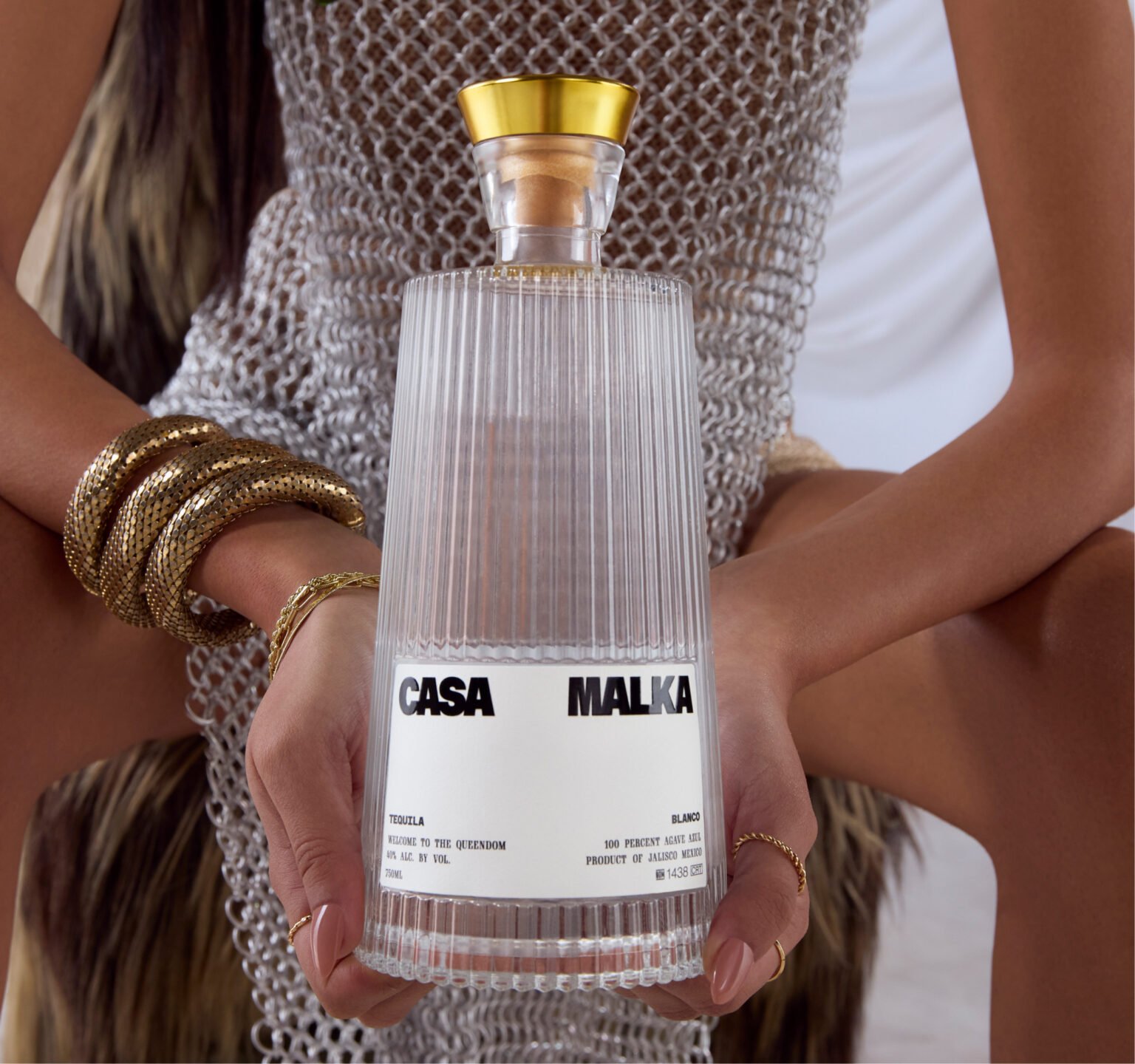 Female holding Casa Malka Blanco Tequila bottle, showcasing premium tequila