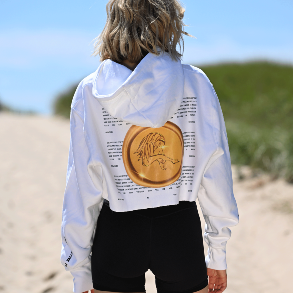 Back view of woman wearing Casa Malka hoodie with gold stamp design