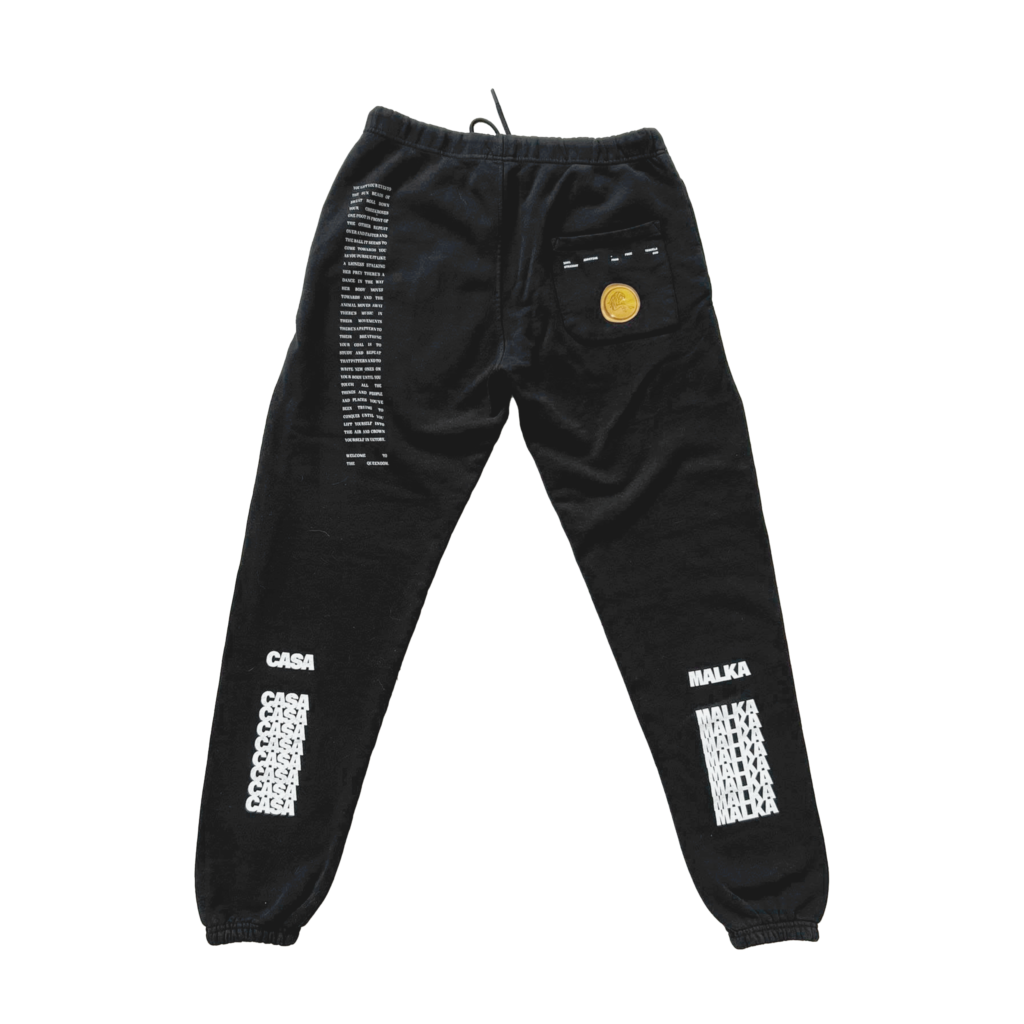 Studio shot of black Casa Malka joggers with gold emblem, back view