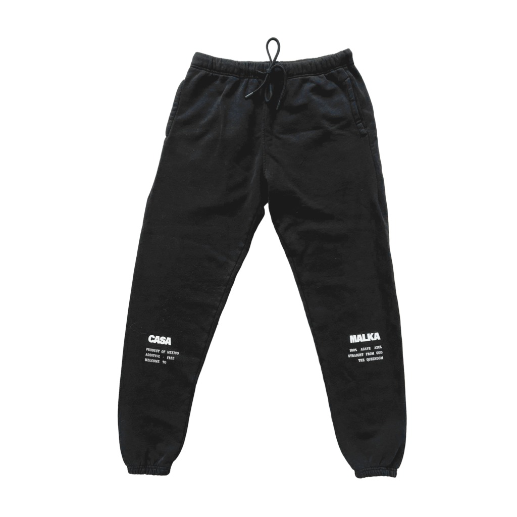 Studio shot of black Casa Malka joggers with white text design, laid flat