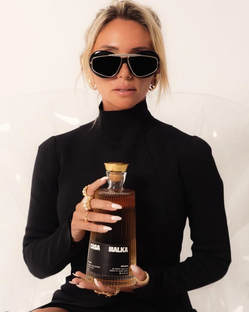 Founder of Casa Malka Tequila holding a bottle of premium reposado tequila